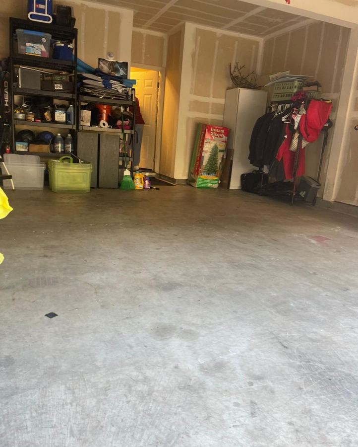 Same garage after organizing, clear floor with shelving in order