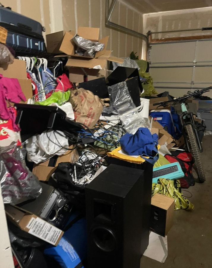 Garage before organizing, packed with boxes and loose items