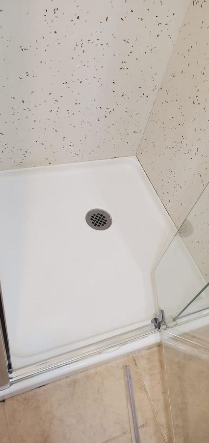 Same shower pan after cleaning, bright white and spotless