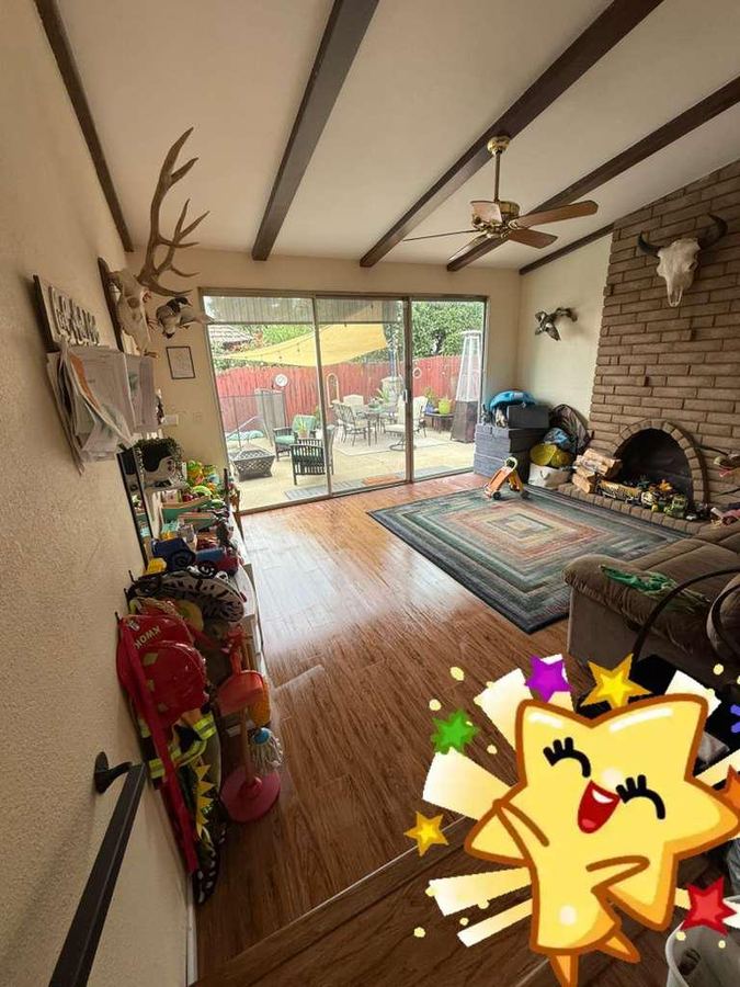Same living room after organizing, clear floor with toys stored